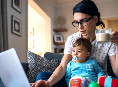 Mother and child sitting in front of laptop