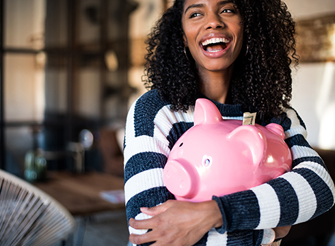Young person holding piggy bank